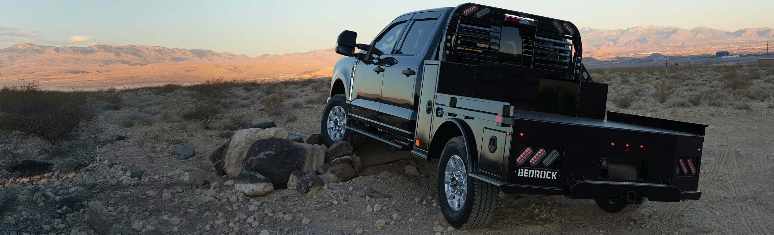 Bedrock Granite Plus flatbed on a truck in a desert mountain landscape