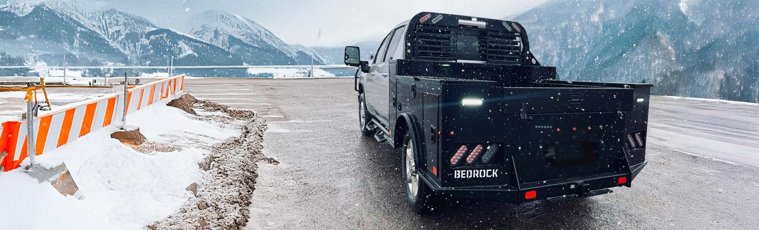 Bedrock Marble Series flatbed on a truck driving through a snowy mountain pass in winter conditions