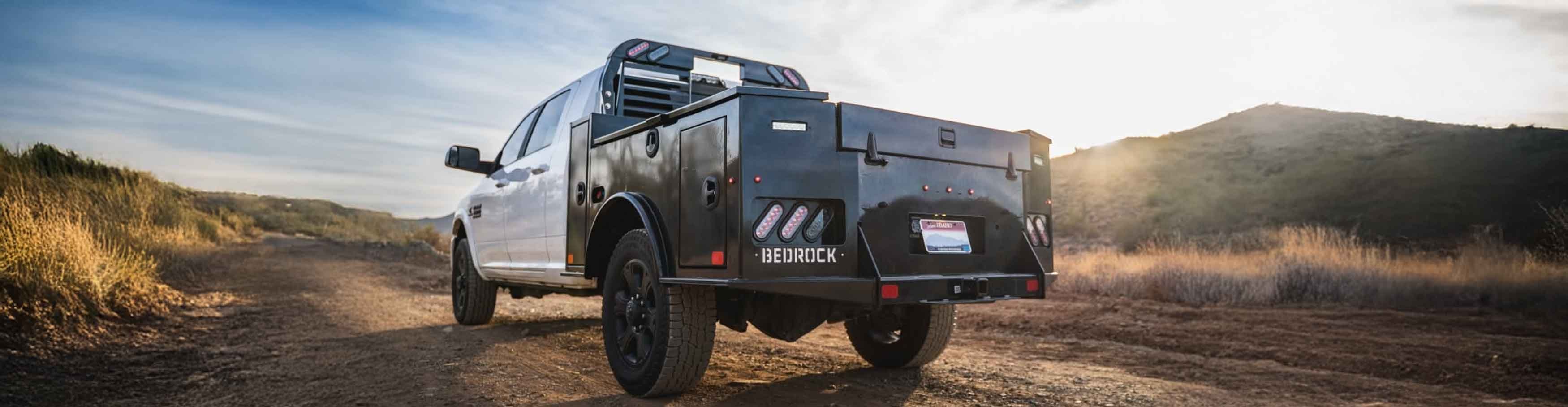 Bedrock Marble Series flatbed on a white RAM truck parked on a desert trail at golden hour